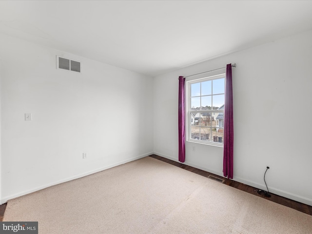 empty room featuring visible vents and baseboards