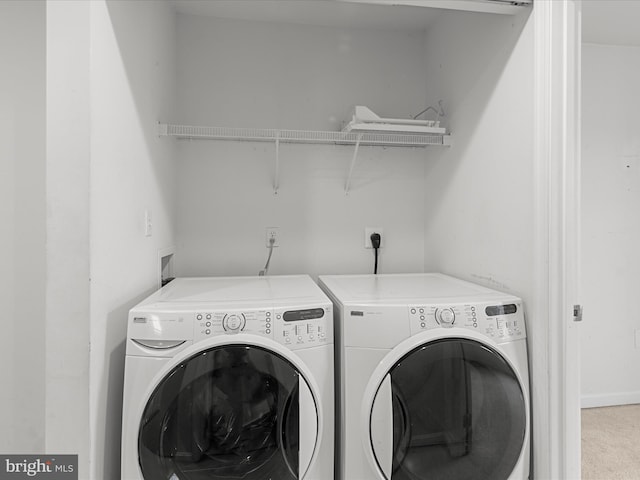 laundry room with laundry area, separate washer and dryer, and carpet flooring