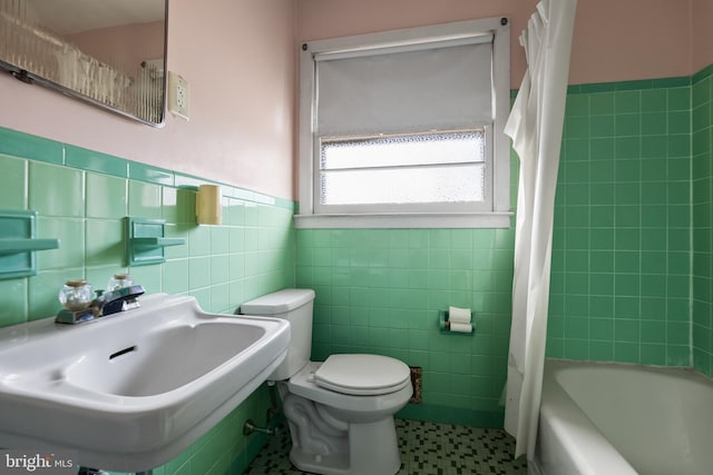 full bathroom featuring sink, tile walls, shower / tub combo, and toilet