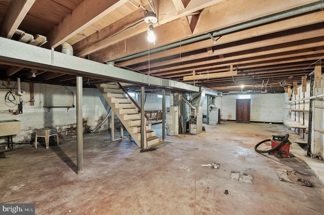 basement with water heater and heating unit