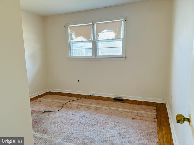 empty room with wood-type flooring