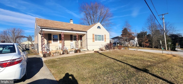 view of front of property featuring a front yard and covered porch