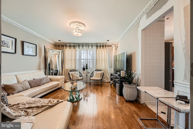 living room featuring wood finished floors and ornamental molding