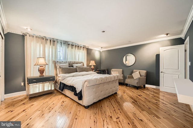 bedroom with baseboards, light wood-style flooring, and ornamental molding