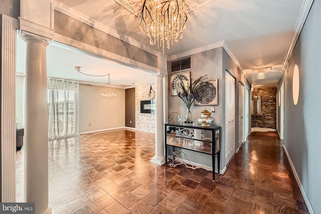 corridor with visible vents, a notable chandelier, ornamental molding, baseboards, and ornate columns