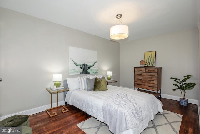 bedroom with dark wood-type flooring