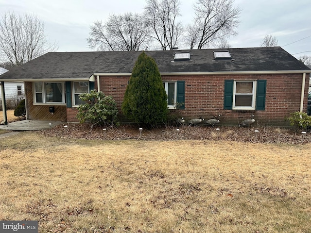 ranch-style home with a front lawn