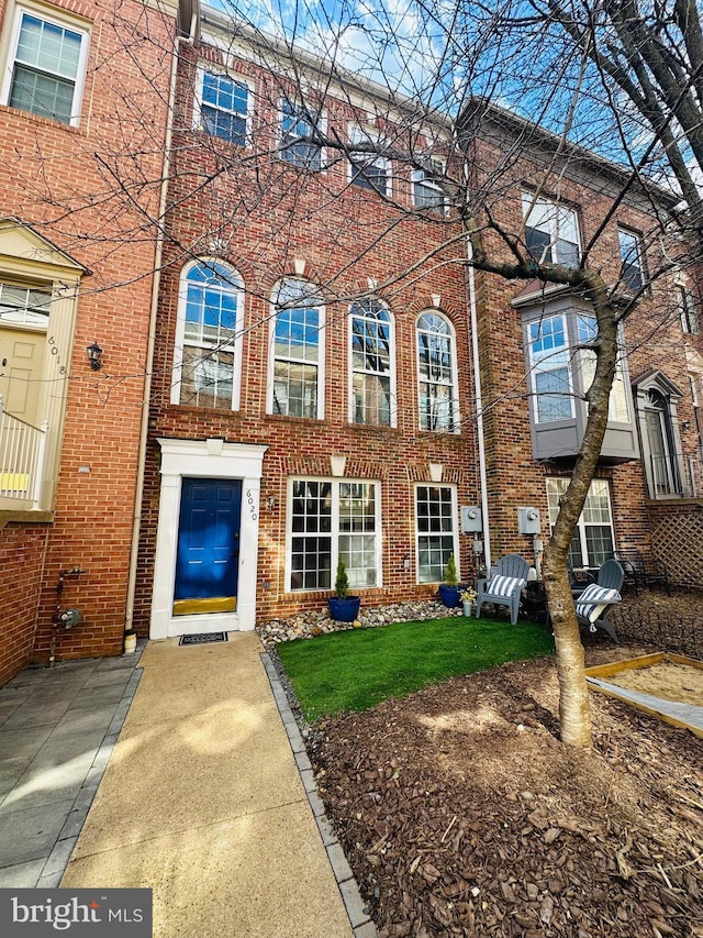 townhome / multi-family property featuring brick siding