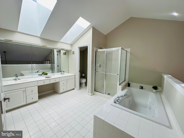 full bath with double vanity, toilet, a sink, a shower stall, and a jetted tub