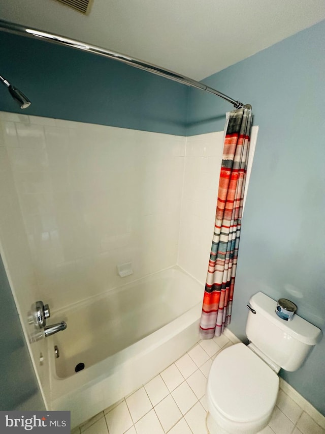 full bathroom with tile patterned flooring, shower / tub combo, and toilet