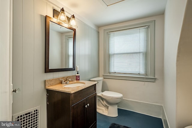 bathroom featuring toilet and vanity