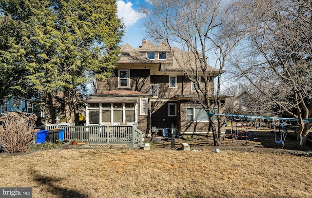 view of front of house featuring a front lawn, a sunroom, and a trampoline