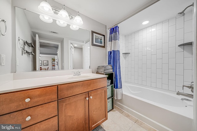 bathroom with shower / bath combo with shower curtain, visible vents, vanity, and tile patterned floors