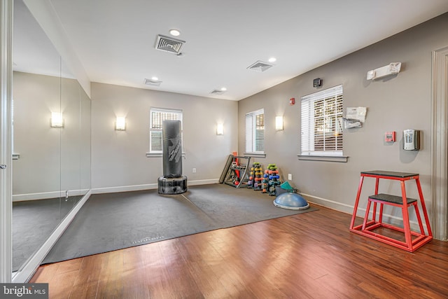 game room with baseboards, visible vents, and wood finished floors