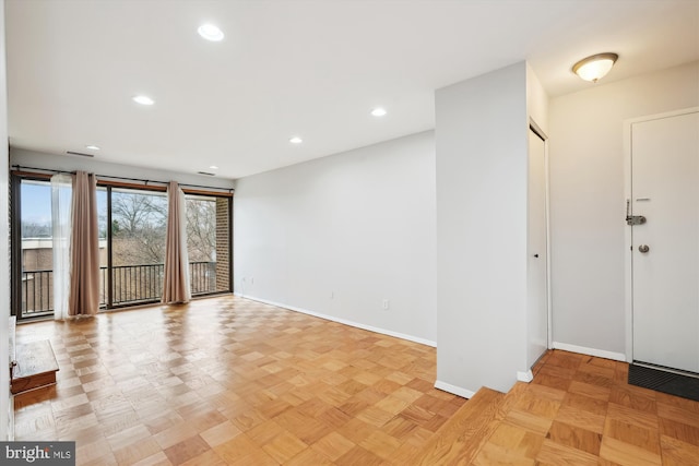 interior space with baseboards and recessed lighting