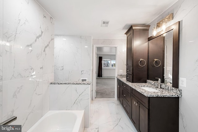 bathroom featuring vanity and a tub to relax in