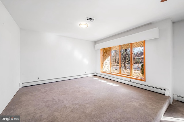 empty room with carpet floors and a baseboard heating unit