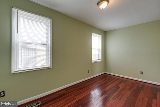 empty room with dark hardwood / wood-style floors