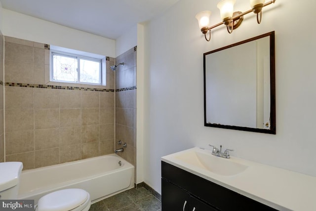 full bathroom with tiled shower / bath combo, vanity, tile patterned floors, and toilet