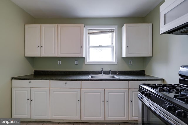 kitchen with white cabinetry, sink, and stainless steel gas range oven