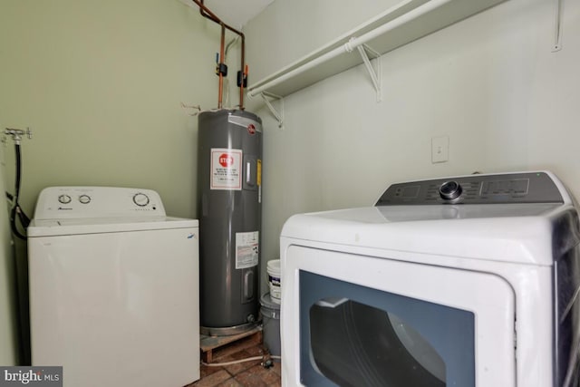 washroom with electric water heater and washer and dryer