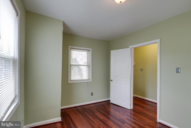 unfurnished bedroom featuring dark wood-type flooring