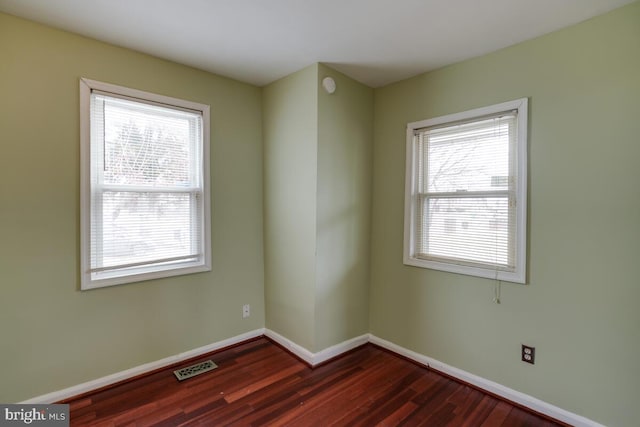 spare room featuring dark wood-type flooring