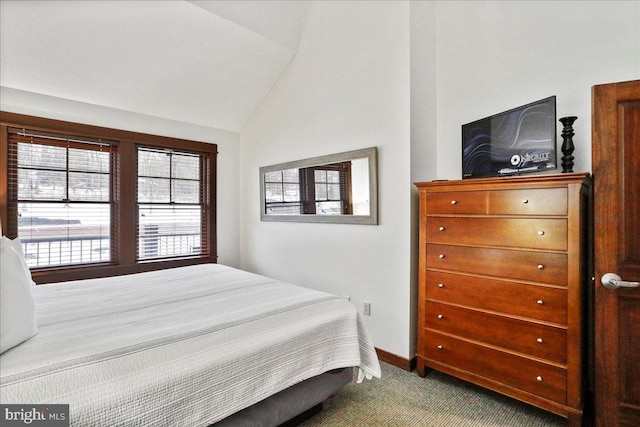 carpeted bedroom featuring vaulted ceiling