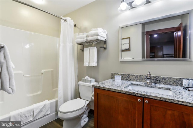 full bathroom with vanity, wood-type flooring, shower / bath combination with curtain, and toilet