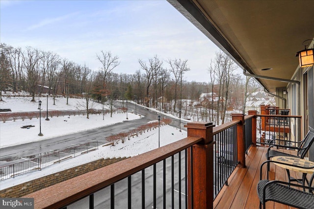 view of snow covered back of property