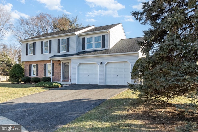 view of front of house with a garage and a front lawn