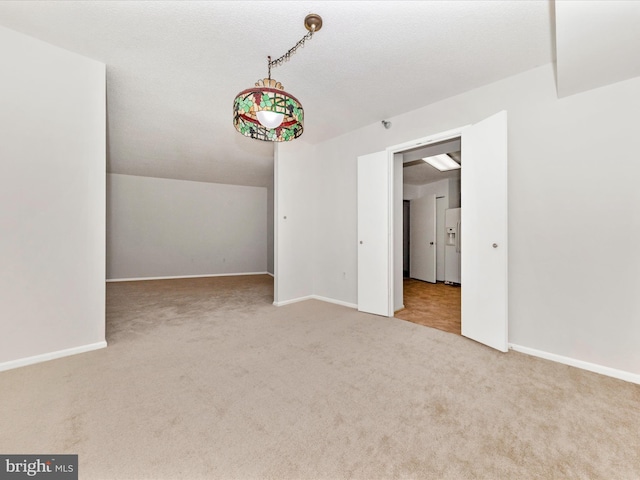 empty room with vaulted ceiling and carpet