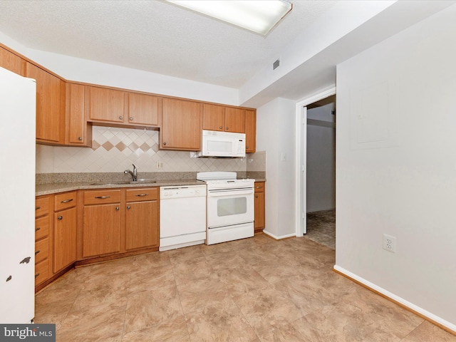 kitchen with sink, a textured ceiling, backsplash, and white appliances