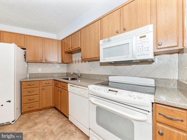 kitchen with sink, white appliances, light stone counters, a textured ceiling, and decorative backsplash