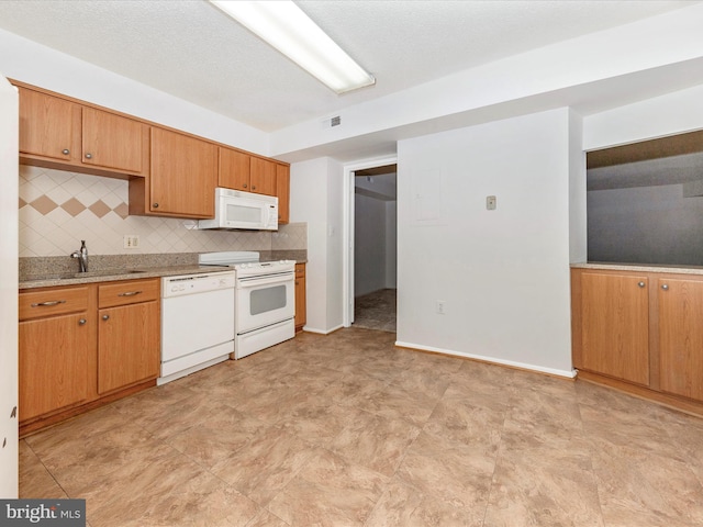 kitchen featuring white appliances, sink, a textured ceiling, and backsplash