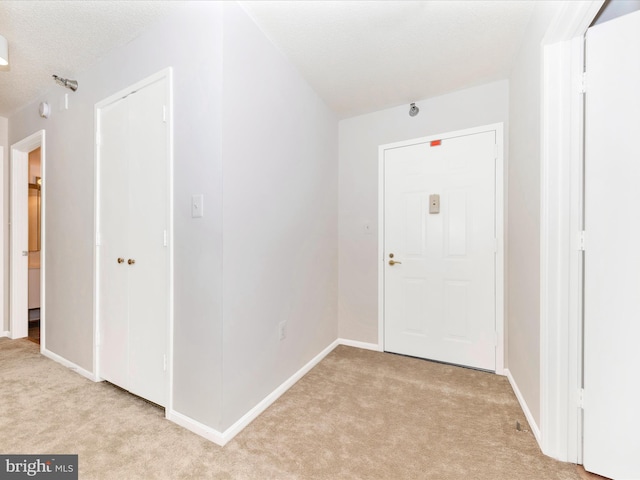 carpeted entrance foyer with a textured ceiling