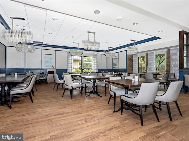 dining room featuring an inviting chandelier and light wood-type flooring