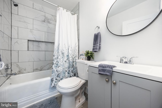 bathroom with shower / tub combo, vanity, and toilet