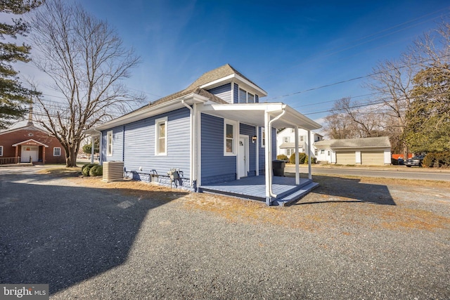 bungalow-style home with covered porch and central AC unit