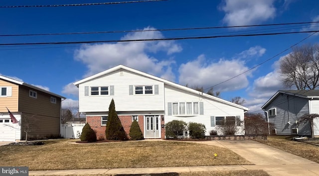 view of front of house featuring brick siding and a front yard