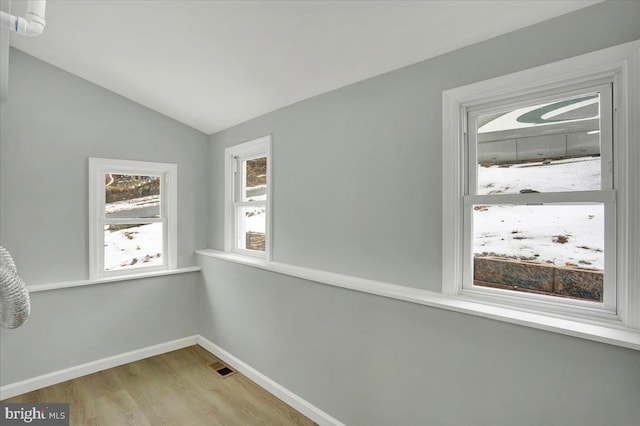 interior space with lofted ceiling and light hardwood / wood-style flooring