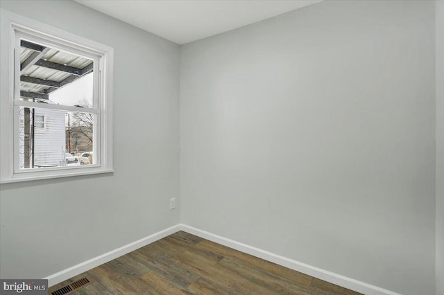 empty room featuring dark hardwood / wood-style flooring