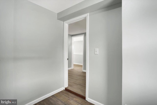 corridor with dark wood-type flooring