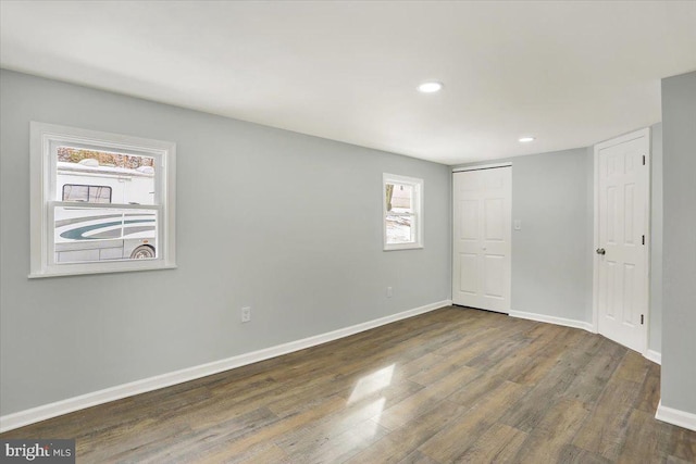 unfurnished bedroom featuring a closet and dark hardwood / wood-style floors