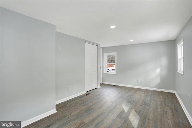 spare room featuring dark wood-type flooring