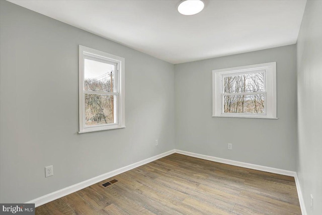 spare room with hardwood / wood-style floors