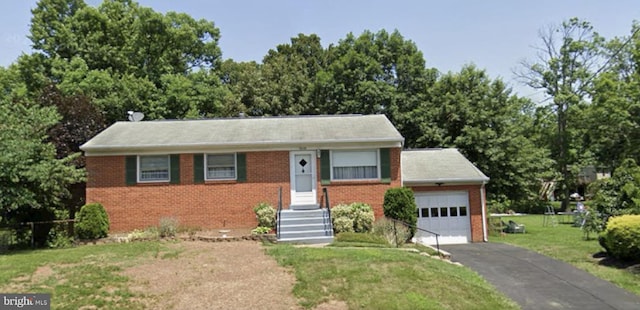 ranch-style home featuring a garage, aphalt driveway, a front yard, and brick siding