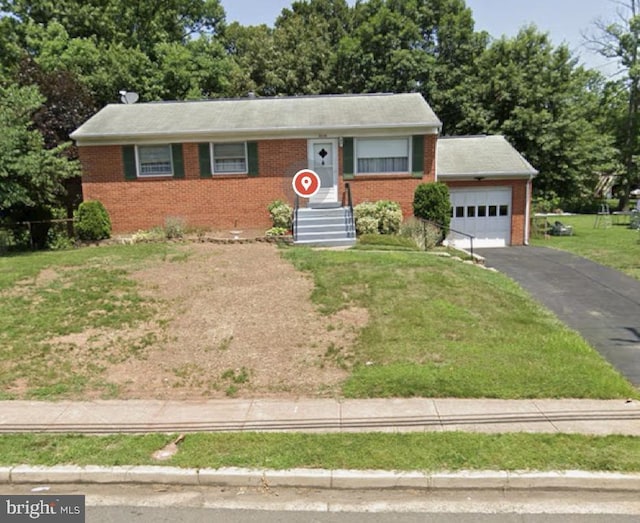 ranch-style house featuring driveway, a front yard, a garage, and brick siding