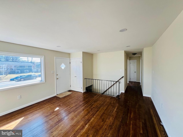 entryway with wood finished floors and baseboards