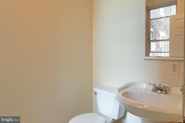 half bath featuring a sink and toilet